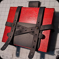 Hip holster for a book.  Intended to carry spellbooks for LARP campaigns.  Adjusts for differents sizes of grimores.